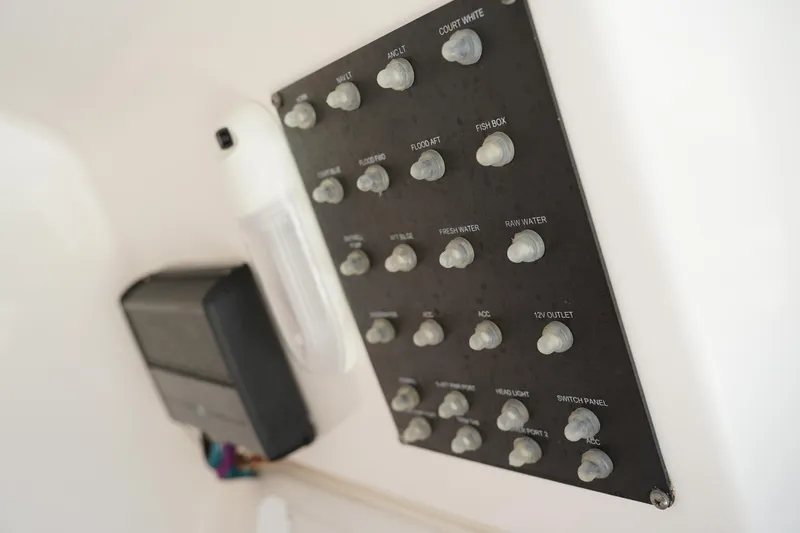 Slide: The Image of Control panel of a 2015 Everglades 243 CC boat with labeled switches. - 23