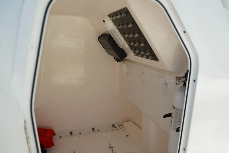 Slide: The Image of Interior cabin of 2015 Everglades 243 CC boat, featuring storage and equipment. - 24