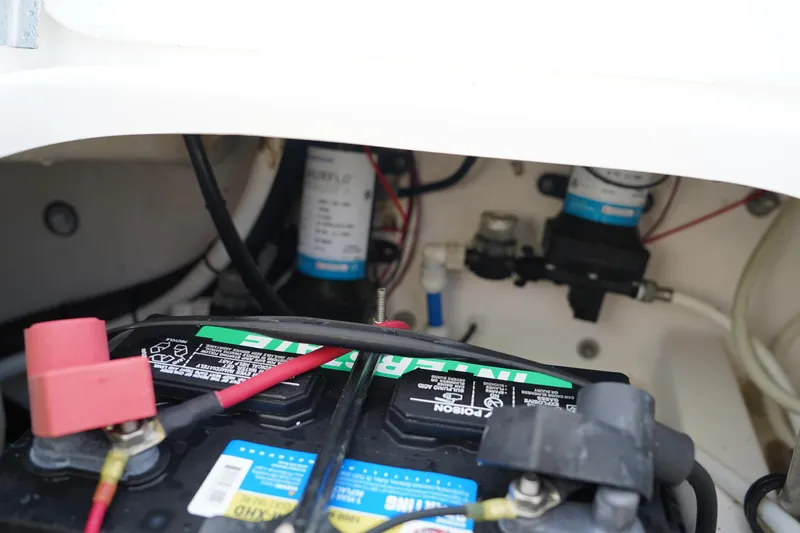 Slide: The Image of Battery compartment of 2015 Everglades 243 CC boat, showing wiring and components. - 27