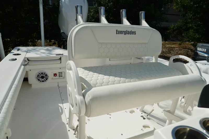 Slide: The Image of 2015 Everglades 243 CC boat interior with white seating and rod holders. - 9
