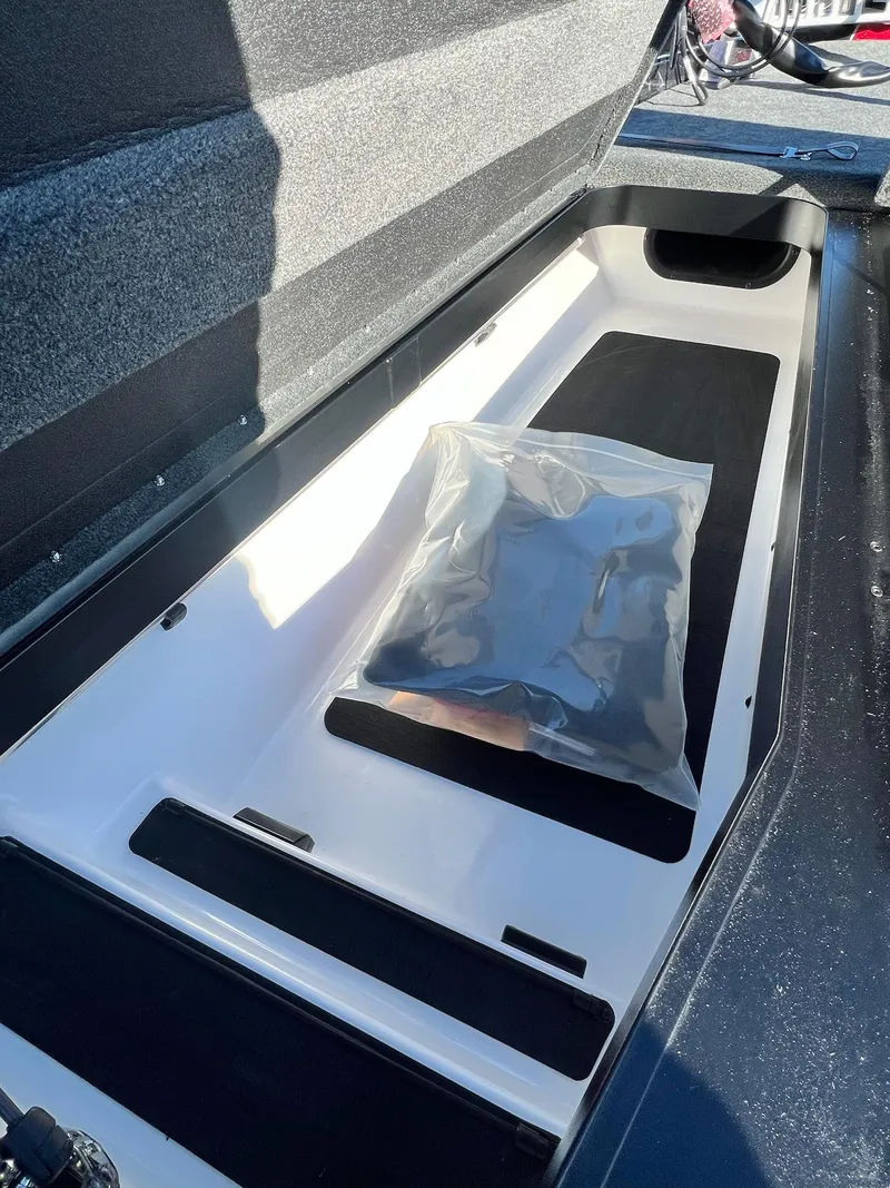 Slide: The Image of Open storage compartment in 2025 Skeeter ZXR 21 boat with packaged item inside. - 10