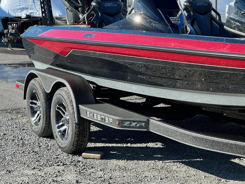 Slide: The Image of 2025 Skeeter ZXR 21 boat on trailer, featuring sleek red and black design. - 12