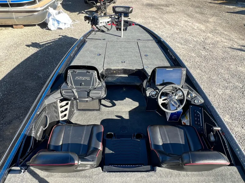 Slide: The Image of 2025 Skeeter ZXR 21 boat interior with dual seats, steering wheel, and control panel. - 13