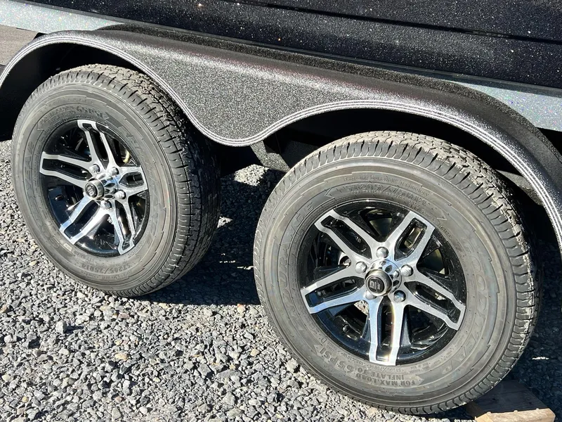 Slide: The Image of 2025 Skeeter ZXR 21 trailer wheels on gravel surface. - 14