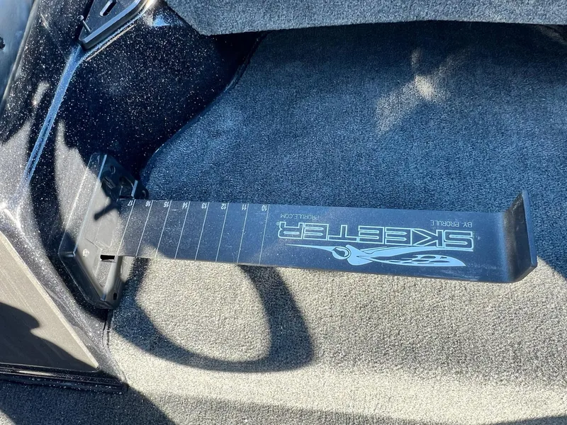 Slide: The Image of Skeeter ZXR 21 boat ruler, 2025 model, on carpeted surface. - 17