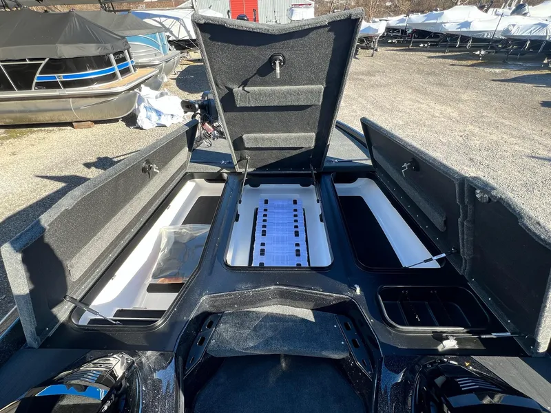 Slide: The Image of 2025 Skeeter ZXR 21 boat storage compartments open, showcasing spacious interior design. - 21