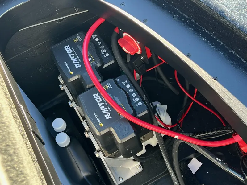 Slide: The Image of Battery compartment of 2025 Skeeter ZXR 21 with Raptor batteries and red cables. - 29