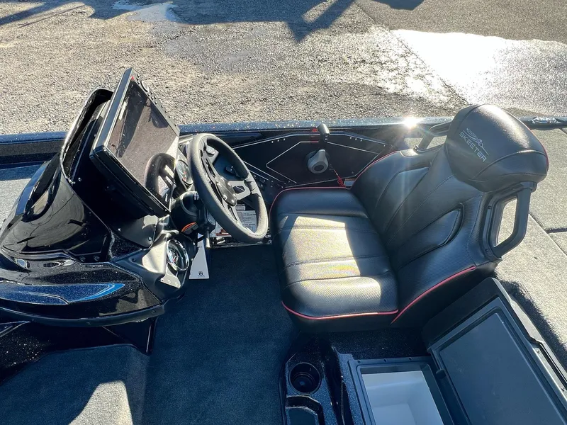 Slide: The Image of 2025 Skeeter ZXR 21 boat interior with steering wheel and seat. - 32