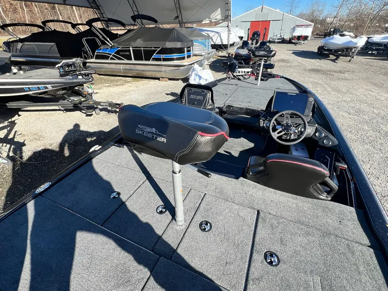 Slide: The Image of 2025 Skeeter ZXR 21 fishing boat interior with steering wheel and seating. - 35