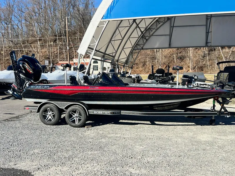Slide: The Image of 2025 Skeeter ZXR 21 boat on trailer, parked outdoors under a canopy. - 4