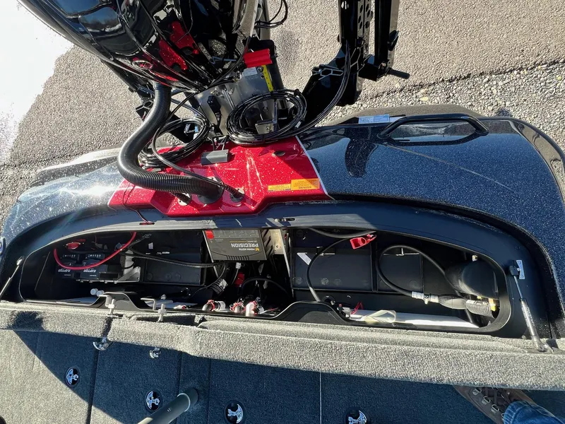 Slide: The Image of 2025 Skeeter ZXR 21 boat engine compartment with wiring and battery setup. - 41