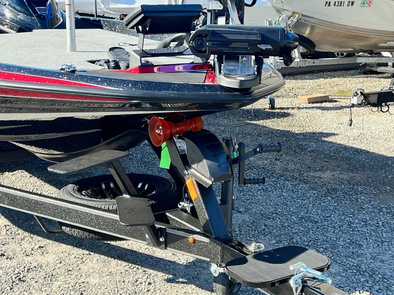 Slide: The Image of 2025 Skeeter ZXR 21 boat trailer hitch and winch on gravel lot. - 45