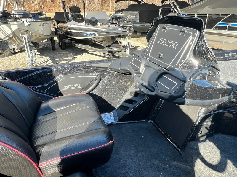 Slide: The Image of 2025 Skeeter ZXR 21 boat interior with black seats and dashboard. - 5