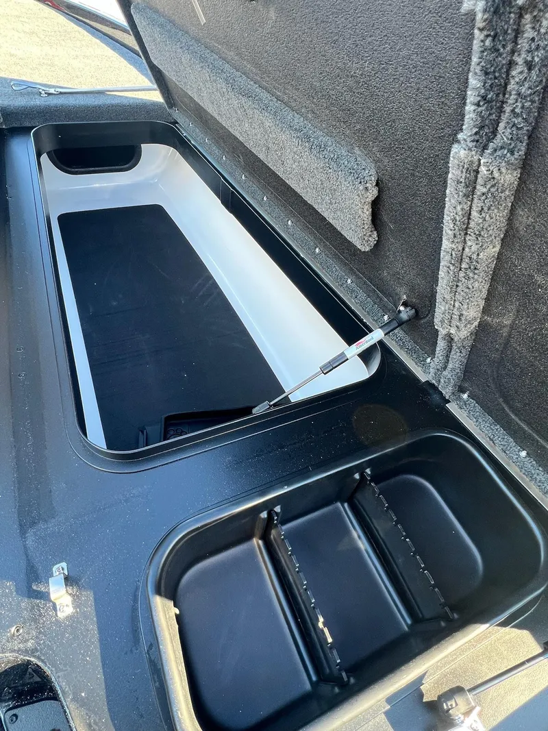 Slide: The Image of Open storage compartment of 2025 Skeeter ZXR 21 boat, showcasing interior design. - 9