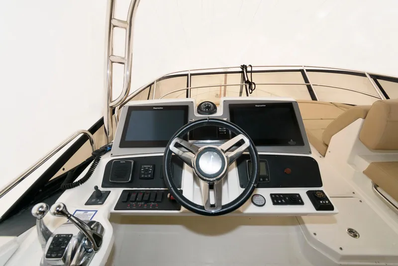 Slide: The Image of 2016 Sea Ray L590 Fly yacht helm with dual screens and controls. - 11