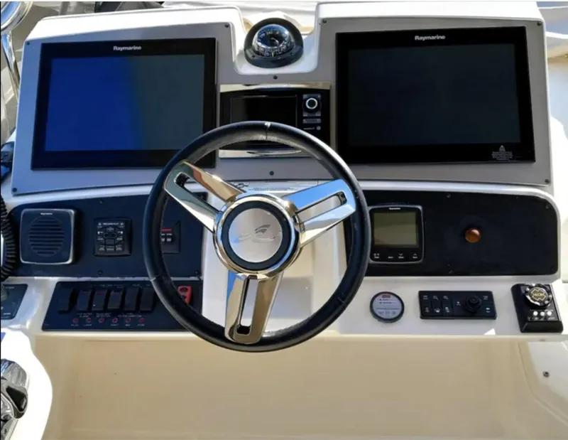 Slide: The Image of Steering console of 2016 Sea Ray L590 Fly yacht with dual Raymarine displays. - 12