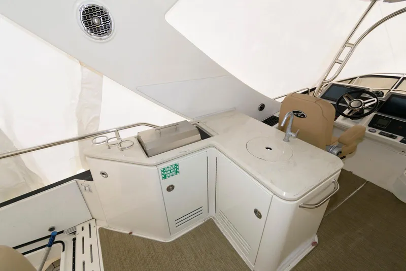 Slide: The Image of 2016 Sea Ray L590 Fly yacht interior with kitchenette and helm station. - 17