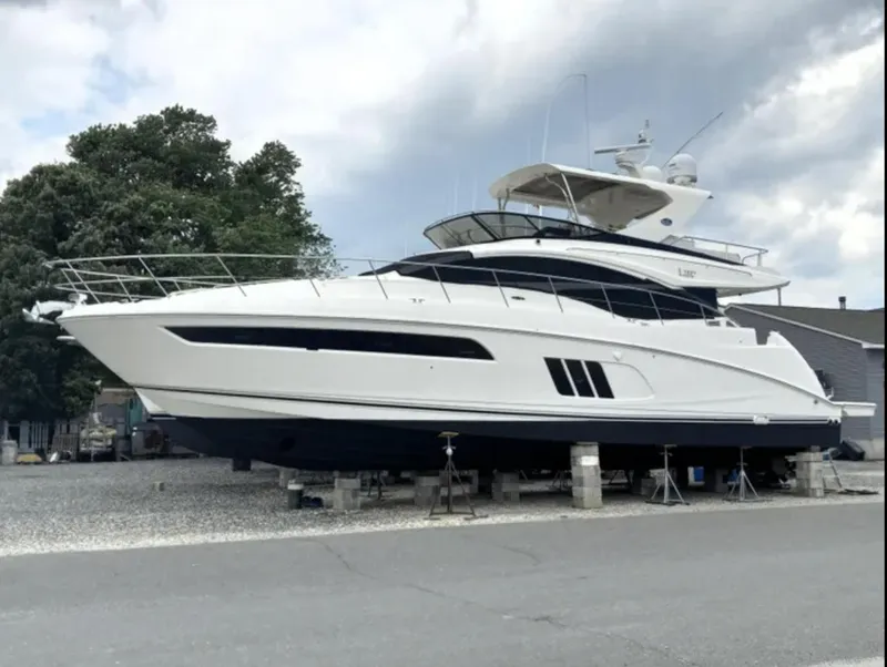 Slide: The Image of 2016 Sea Ray L590 Fly yacht on dry dock, side view. - 2