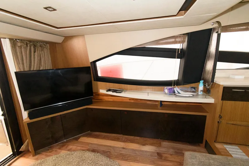Slide: The Image of Luxurious interior of 2016 Sea Ray L590 Fly yacht with modern TV and sleek design. - 20