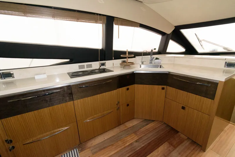Slide: The Image of Luxurious kitchen interior of 2016 Sea Ray L590 Fly yacht with modern cabinetry. - 23