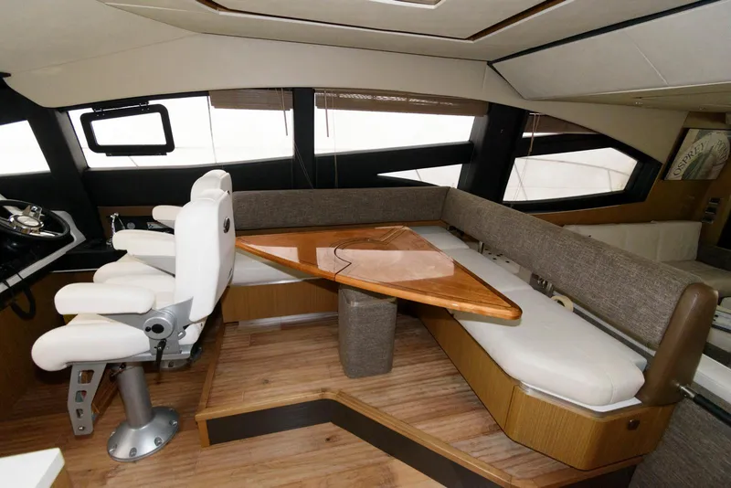 Slide: The Image of Luxurious interior of 2016 Sea Ray L590 Fly yacht with plush seating and elegant wood table. - 24