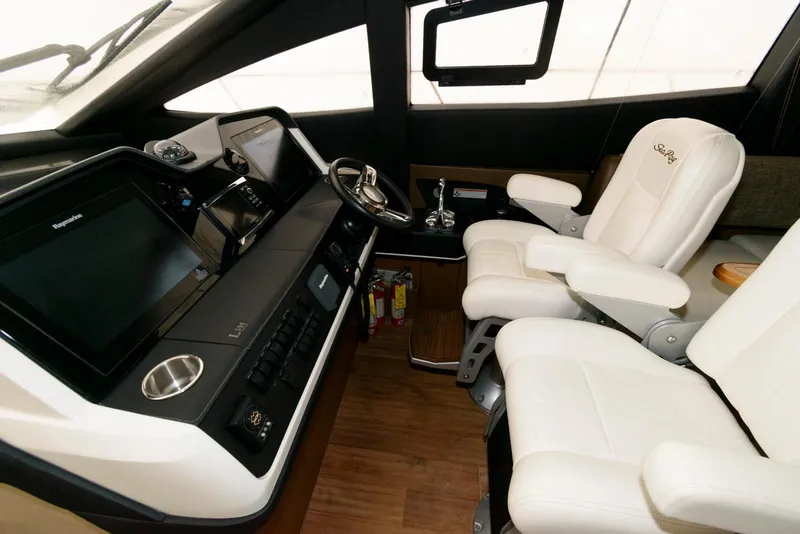 Slide: The Image of Luxurious 2016 Sea Ray L590 Fly yacht cockpit with modern controls and plush seating. - 25