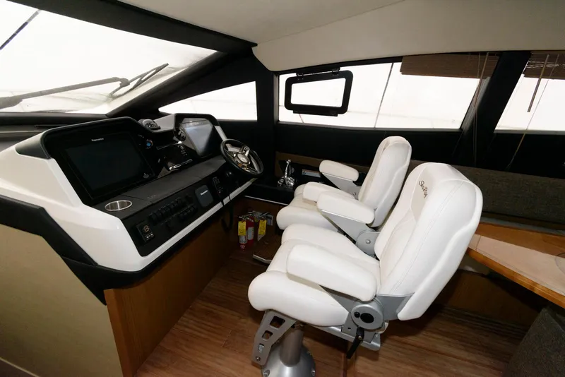 Slide: The Image of Interior helm of 2016 Sea Ray L590 Fly yacht with modern controls and seating. - 26