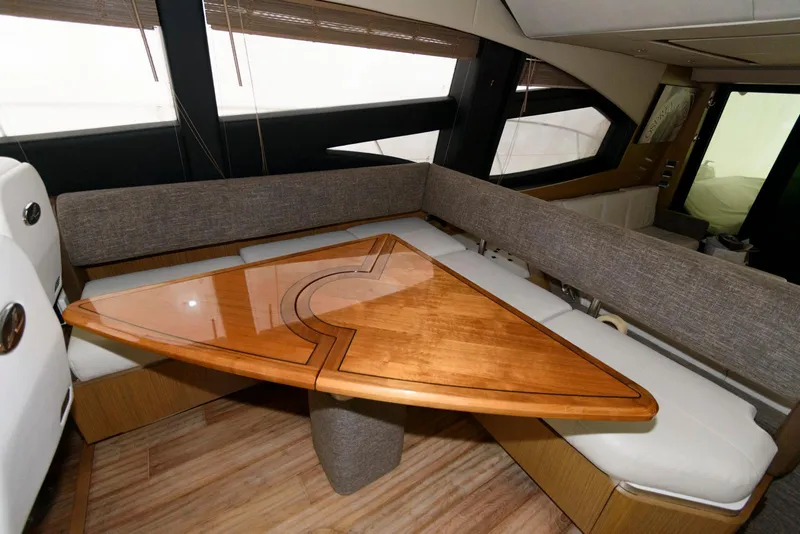 Slide: The Image of Luxurious interior of 2016 Sea Ray L590 Fly yacht with elegant wooden table and seating. - 27