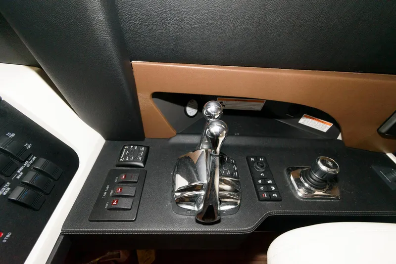 Slide: The Image of Control panel of 2016 Sea Ray L590 Fly yacht with joystick and switches. - 28