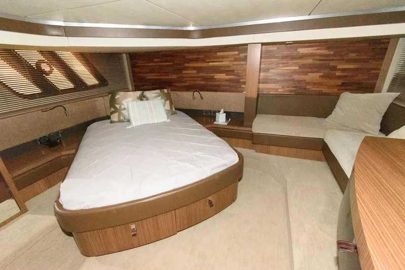Slide: The Image of Luxurious 2016 Sea Ray L590 Fly yacht bedroom with wood accents and cozy seating. - 30