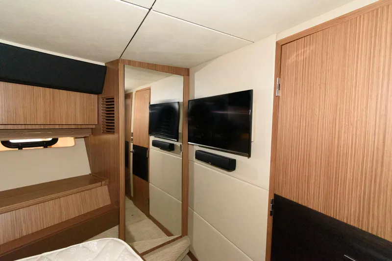 Slide: The Image of Interior of 2016 Sea Ray L590 Fly yacht with modern wood paneling and mounted TV. - 38