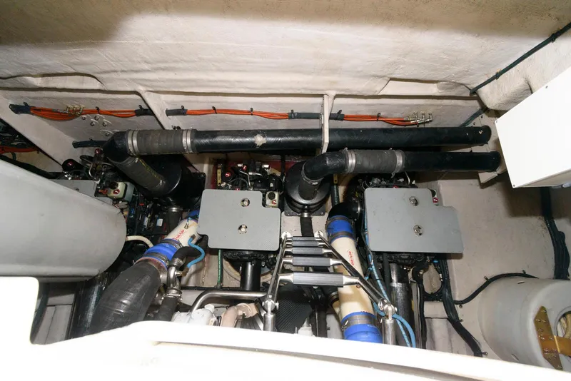 Slide: The Image of Engine room of 2016 Sea Ray L590 Fly yacht, showcasing mechanical components and piping. - 48