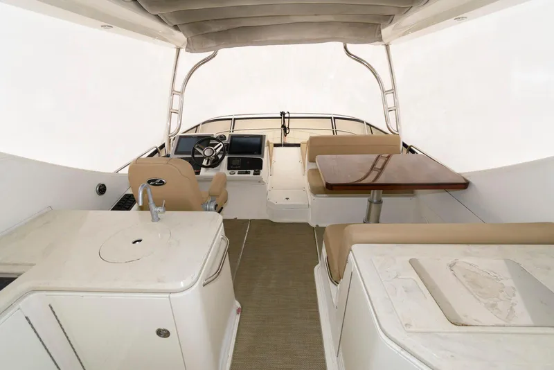 Slide: The Image of Interior of 2016 Sea Ray L590 Fly yacht with helm and seating area. - 8