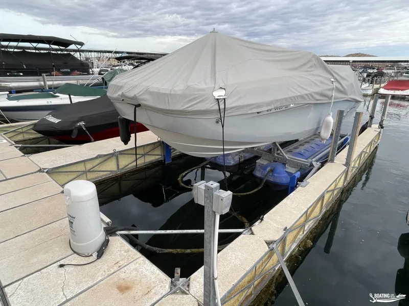 Slide: The Image of 2021 Bayliner DX 2250 boat covered at marina dock. - 10