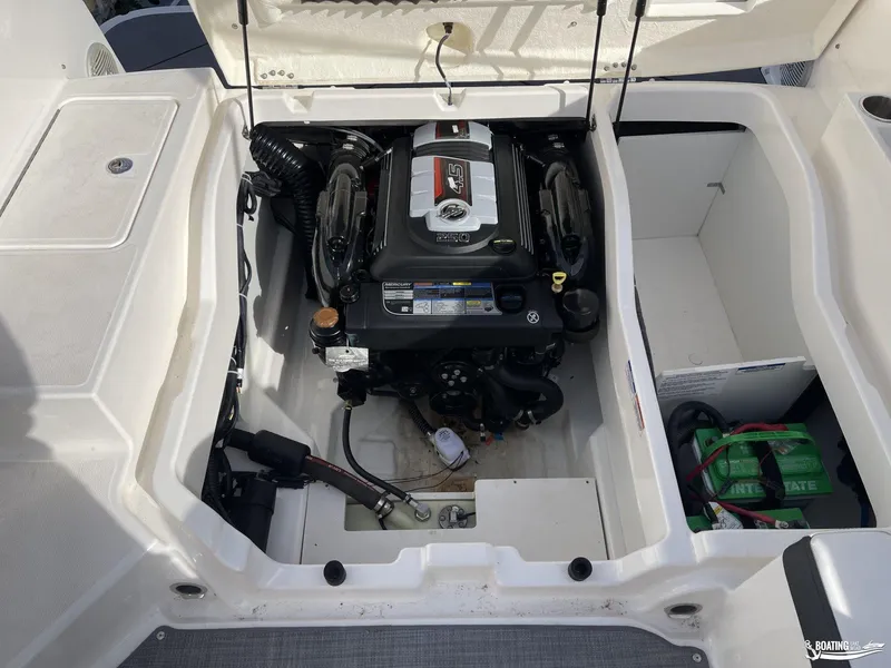Slide: The Image of 2021 Bayliner DX 2250 boat engine compartment with visible battery and components. - 16