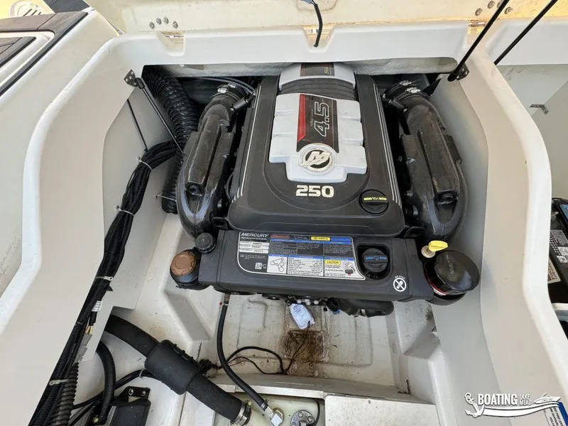 Slide: The Image of 2021 Bayliner DX 2250 boat engine compartment with Mercury 4.5L 250 HP engine. - 18