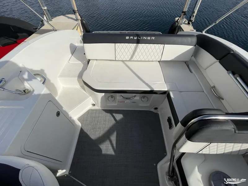Slide: The Image of Interior of 2021 Bayliner DX 2250 boat with cushioned seating and storage. - 7