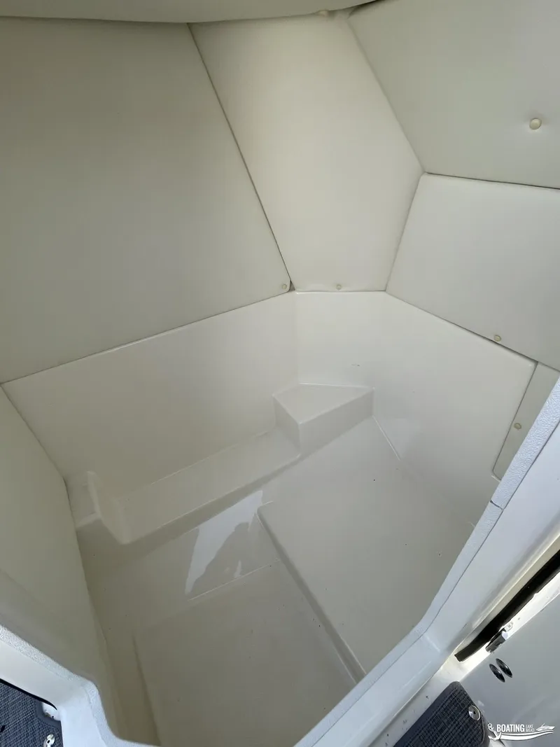 Slide: The Image of Interior cabin of 2021 Bayliner DX 2250 boat, featuring white padded walls. - 9