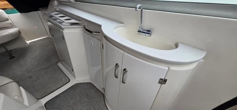 Slide: The Image of 2002 Monterey 322 Cruiser interior with sink and storage cabinets. - 15