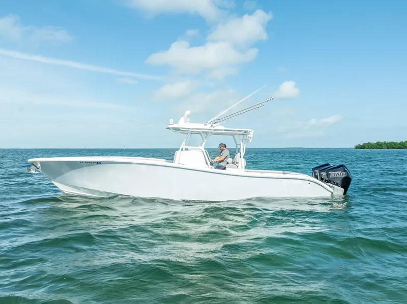 Slide: The Image of 2020 Yellowfin 34 boat cruising on open water under a clear blue sky. - 0
