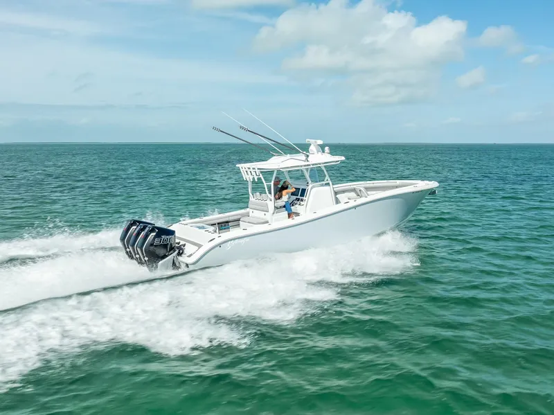 Slide: The Image of 2020 Yellowfin 34 boat cruising on open water under a clear sky. - 17
