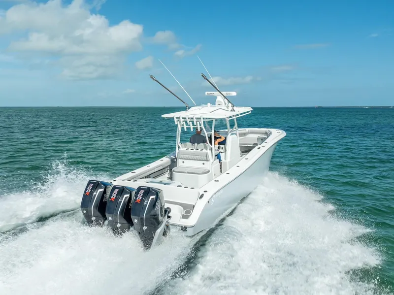 Slide: The Image of 2020 Yellowfin 34 boat cruising on open water with triple outboard engines. - 19