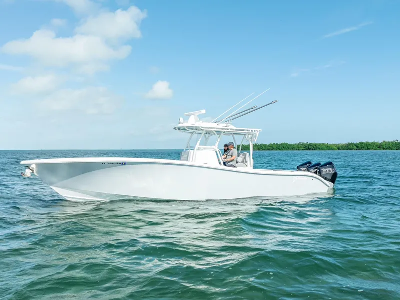 Slide: The Image of 2020 Yellowfin 34 boat cruising on open water under clear blue sky. - 2