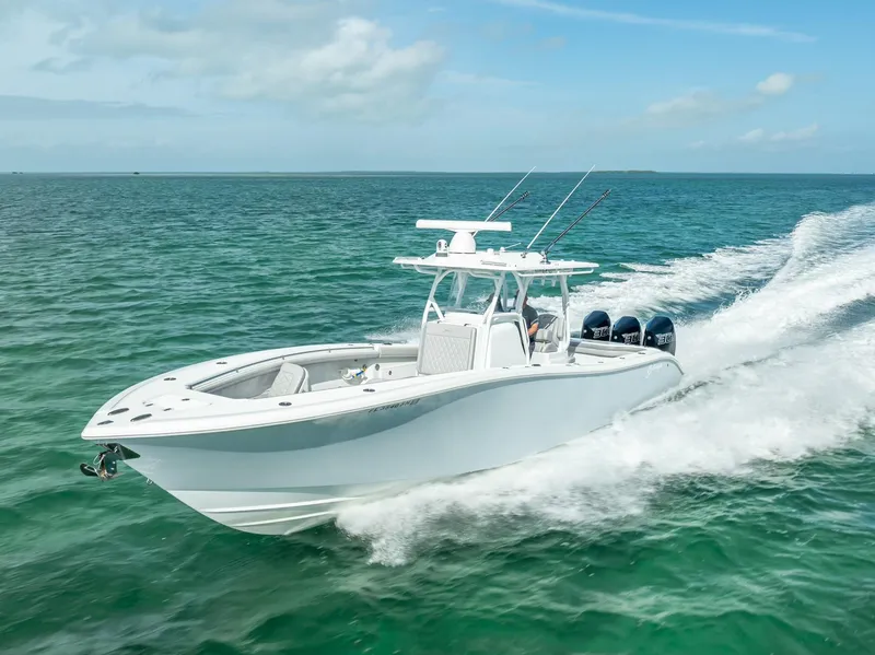 Slide: The Image of 2020 Yellowfin 34 boat cruising on open water, showcasing sleek design and powerful engines. - 23
