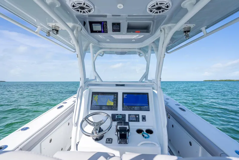 Slide: The Image of 2020 Yellowfin 34 boat cockpit with advanced navigation system on open water. - 26