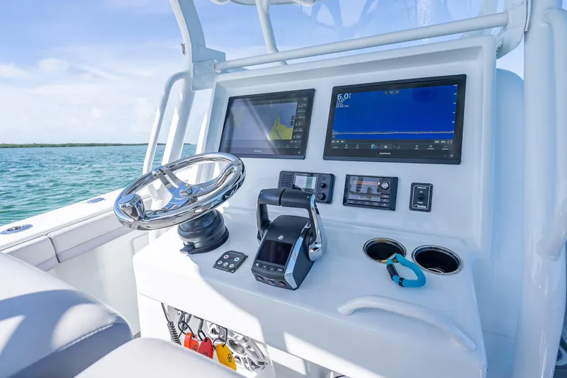 Slide: The Image of 2020 Yellowfin 34 boat dashboard with modern controls and dual screens. - 27