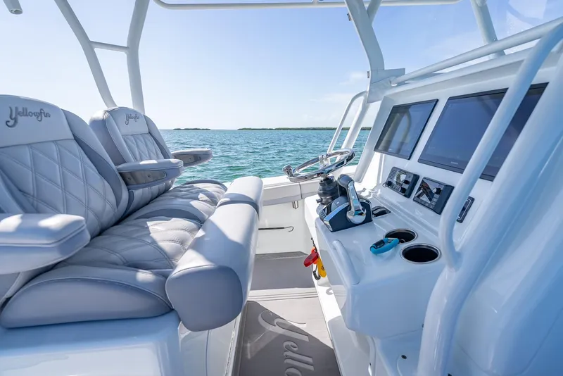 Slide: The Image of 2020 Yellowfin 34 boat interior with plush seating and modern dashboard on open water. - 32
