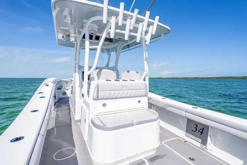 Slide: The Image of 2020 Yellowfin 34 boat on clear blue water, showcasing sleek design and spacious deck. - 38