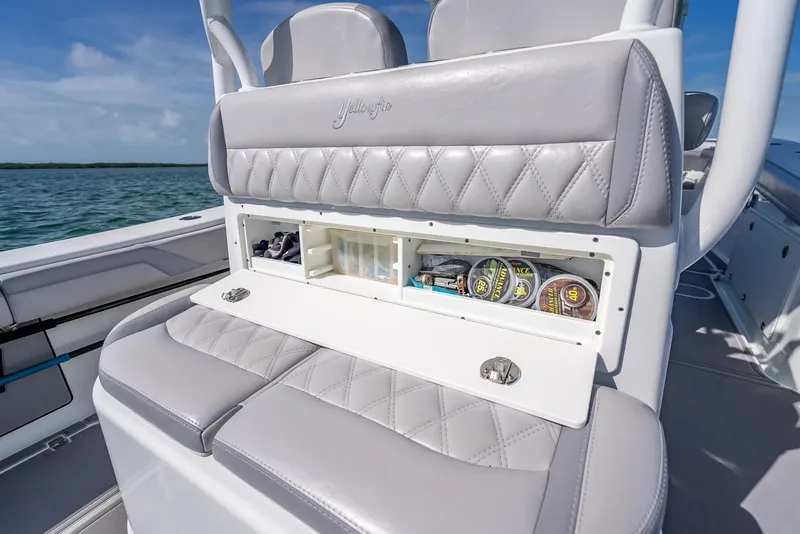 Slide: The Image of 2020 Yellowfin 34 boat seat with storage compartment, featuring luxurious gray upholstery. - 48