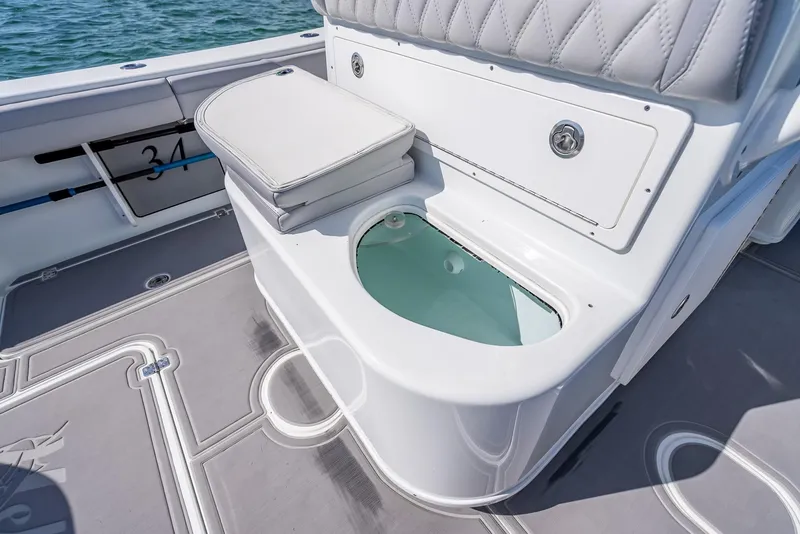 Slide: The Image of 2020 Yellowfin 34 boat interior with cushioned seating and storage compartment. - 49